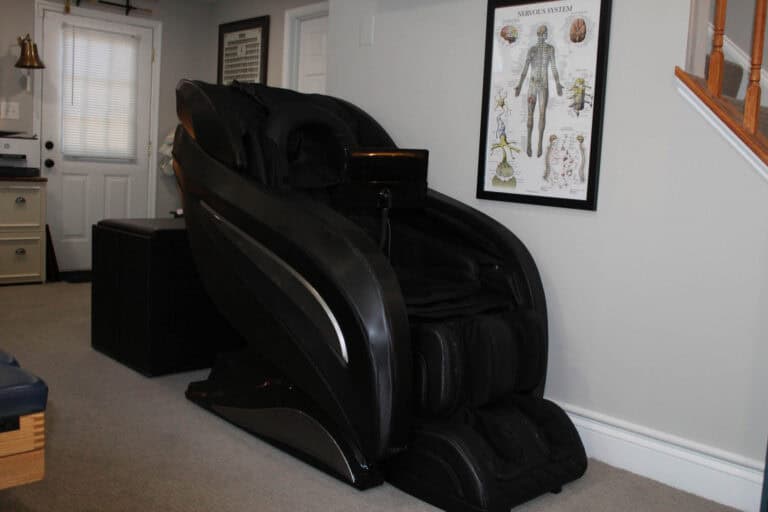 Black massage chair in therapy room