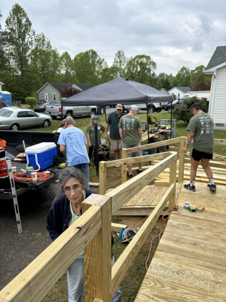 Volunteers building a wooden ramp for accessibility.
