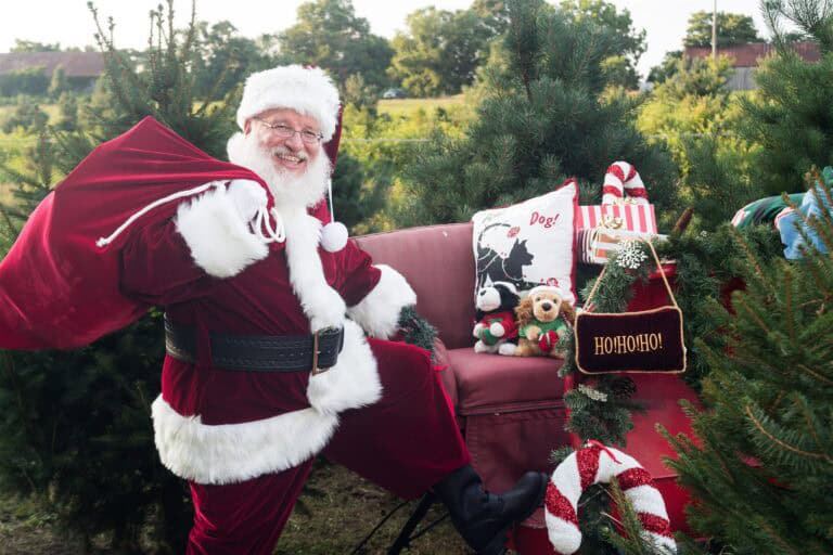 Santa Claus with red sack, toys, and decorations