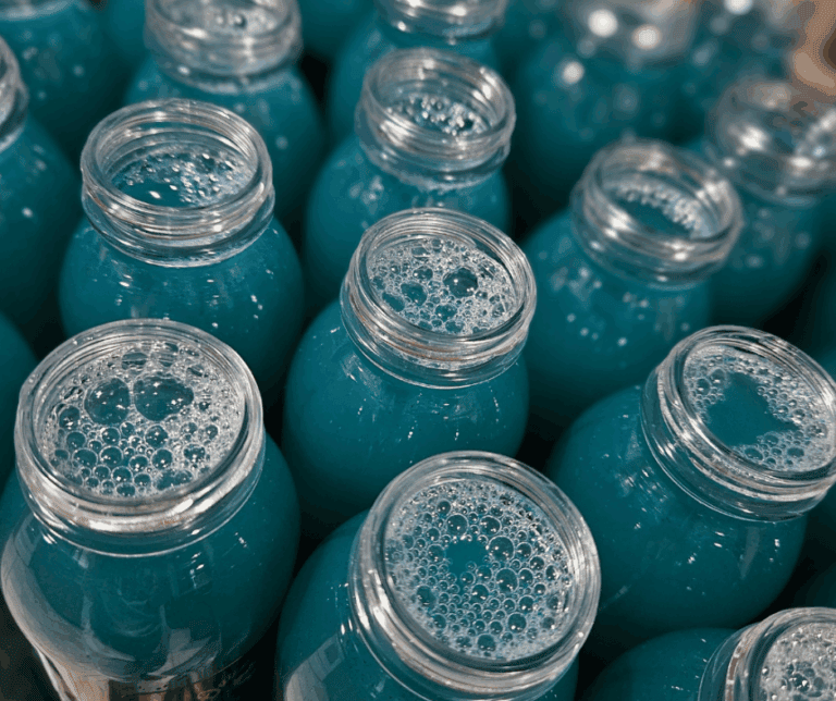 Rows of blue liquid-filled jars.